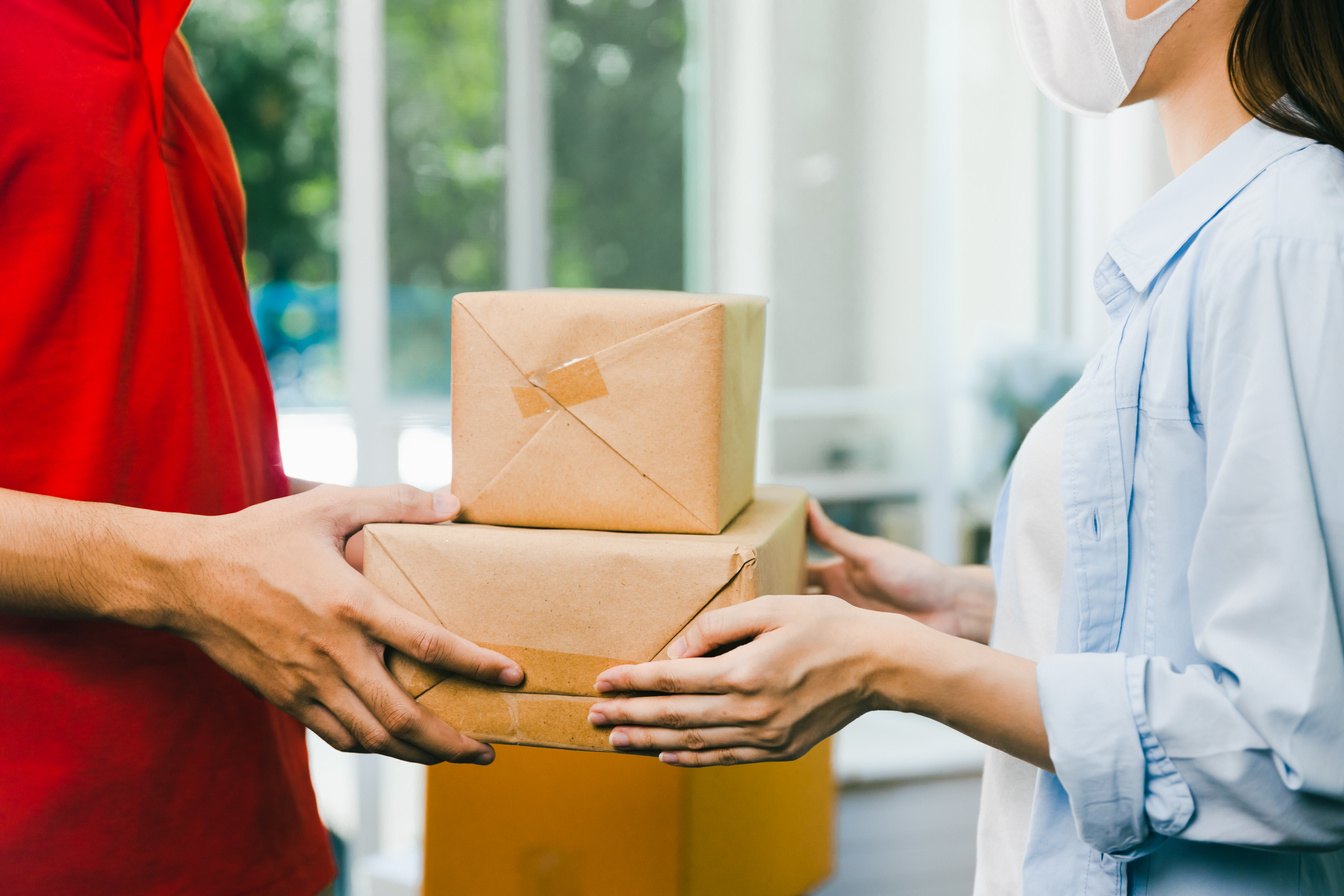 Delivery Man Delivers Parcels to Female Client